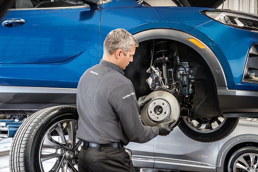 A service tech working on a car