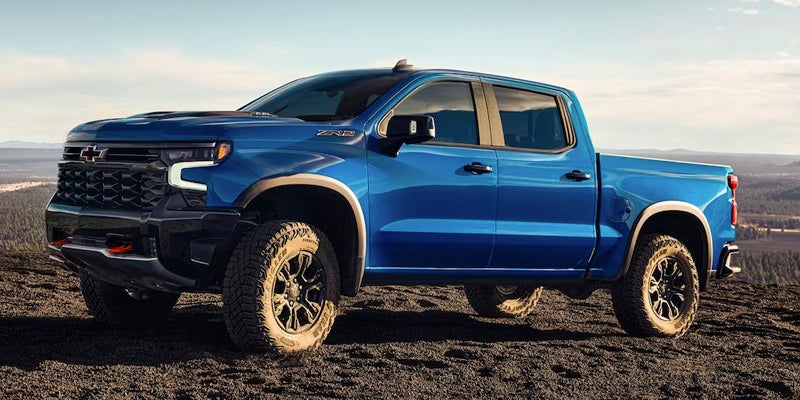 Blue Silverado 1500 running off-roading in desert area