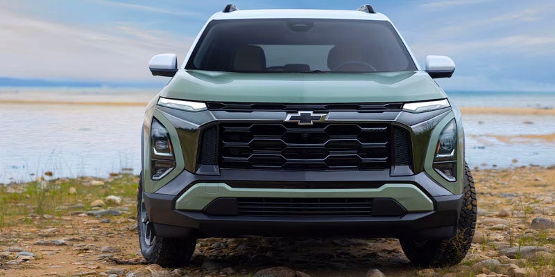 Green Chevy Equinox front side view Standing Near river