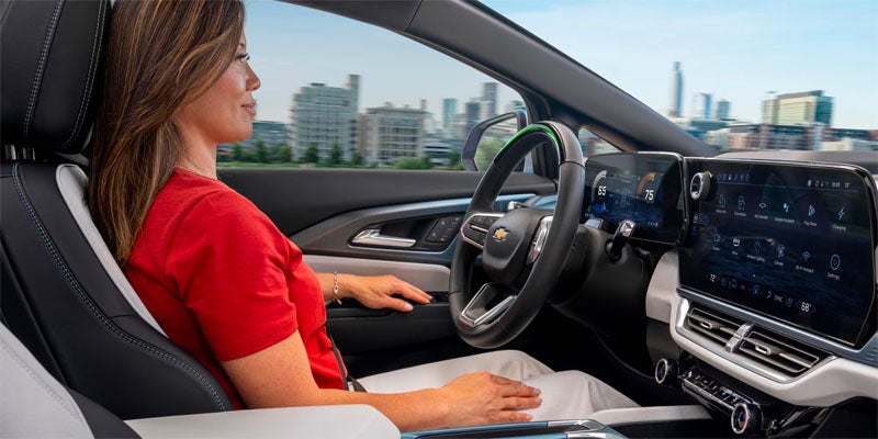 A lady Comfortably driving Chevy Equinox EV