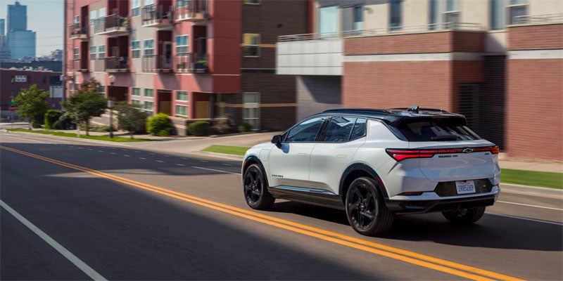 White Equinox EV running on road