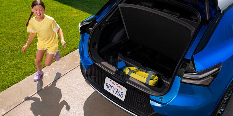 A girl taking his bag for Chevy Equinox EV bootspace