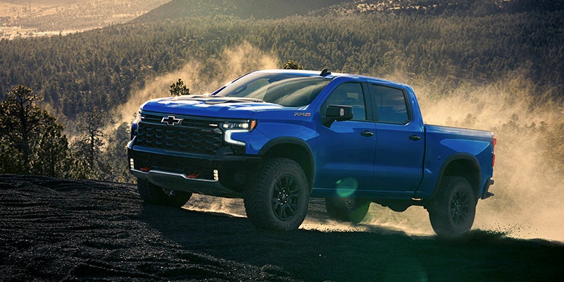 Blue chevy Silverado 1500 in hill section for off-roading