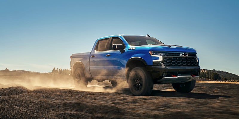 Blue Silverado off-roading in desert section