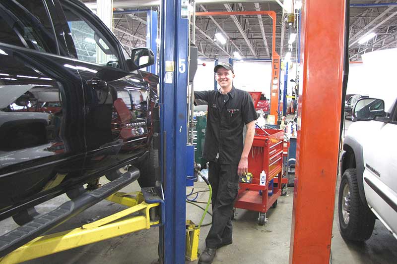 A service technicians at Heritage Chevrolet -MI fixing a customers car